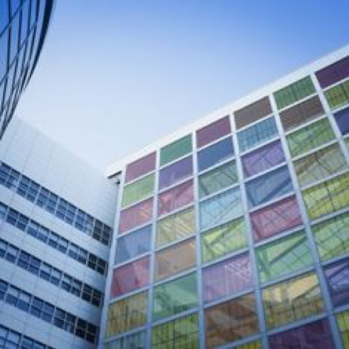 Toekomstvisie waarbij perovskiet-zonnecellen in de ramen van een gebouw gebruikt worden, zogenaamde building-integrated PV.